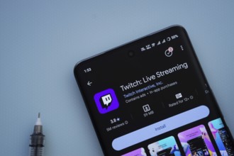 Dhaka, Bangladesh- 30 Sep 2025: On a blue surface, a smartphone displays the Twitch app within the