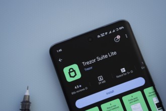 Dhaka, Bangladesh- 30 Sep 2025: On a blue surface, a smartphone displays the Trezor app with in the