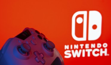 Dhaka, Bangladesh- 15 July 2025: A close-up of a gamepad with thenintendo switch seen on screen in