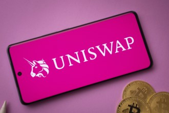 Dhaka, Bangladesh- 15 June 2025: Uniswap logo on smartphone screen near Bitcoin coin and QR code on