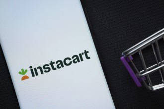 Dhaka, Bangladesh- 03 July 2025: A smartphone displaying the Instacart logo next to a miniature