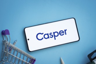 Dhaka, Bangladesh- 03 July 2025: Smartphone displaying Casper logo with shopping cart on a blue