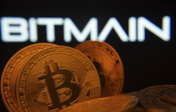Dhaka, Bangladesh- 15 June 2025: Close-up of Bitcoin coins with the Bitmain logo visible on a