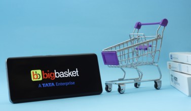 Dhaka, Bangladesh- 03 July 2025: Smartphone with BigBasket logo next to a small shopping cart and