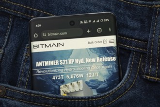 Dhaka, Bangladesh- 15 June 2025: A smartphone displaying the Bitmain.com web interface peeks out of