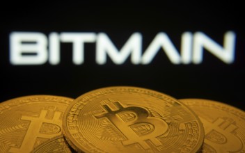 Dhaka, Bangladesh- 03 Sep 2025: Close-up of Bitcoin coins with the Bitmain logo visible on a screen