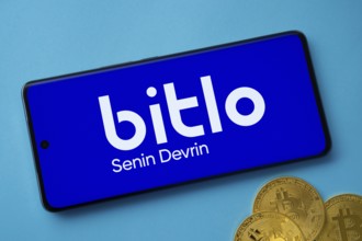Dhaka, Bangladesh- 03 Sep 2025: Bitlo logo on smartphone screen near Bitcoin coin and QR code on