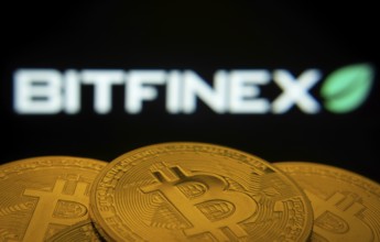 Dhaka, Bangladesh- 15 June 2025: Close-up of Bitcoin coins with the Bitfinex logo visible on a