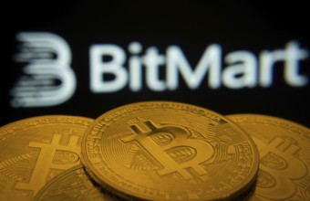 Dhaka, Bangladesh- 03 Sep 2025: Close-up of Bitcoin coins with the Bitmart logo visible on a screen