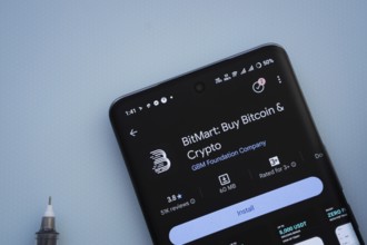 Dhaka, Bangladesh- 29 May 2025: On a blue surface, a smartphone displays the BitMart app within the