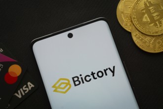 Dhaka, Bangladesh- 09 Sep 2025: Smartphone displaying Bictory logo surrounded by Bitcoin coins and
