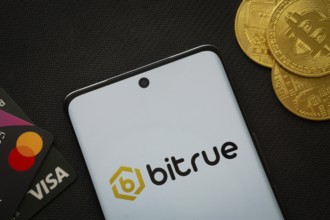 Dhaka, Bangladesh- 06 Sep 2025: Smartphone displaying Bitrue logo surrounded by Bitcoin coins and