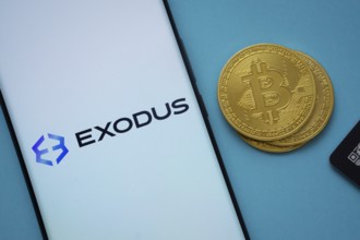 Dhaka, Bangladesh- 06 Sep 2025: Exodus logo on smartphone screen near Bitcoin coin and QR code on