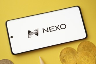 Dhaka, Bangladesh- 06 Sep 2025: Nexo logo on smartphone screen near Bitcoin coin and QR code on
