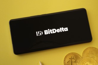 Dhaka, Bangladesh- 02 June 2025: BigDelta logo on smartphone screen near Bitcoin coin and QR code