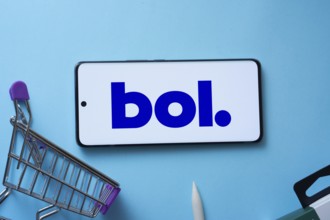 Dhaka, Bangladesh- 03 July 2025: Smartphone displaying bol logo with shopping cart on a blue