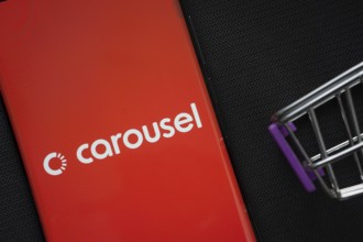 Dhaka, Bangladesh- 03 July 2025: A smartphone displaying the Carousell logo next to a miniature