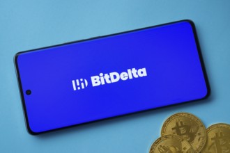 Dhaka, Bangladesh- 02 June 2025: BitDelta logo on smartphone screen near Bitcoin coin and QR code