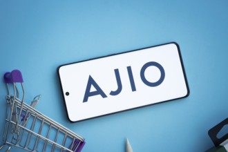 Dhaka, Bangladesh- 03 July 2025: Smartphone displaying AJIO logo with shopping cart on a blue