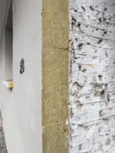 The façade of an apartment building is being energetically renovated with mineral wool insulation