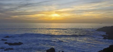The sun sets over the ocean with visible waves, hiking the Fisherman's Trail, fishing trail, rota