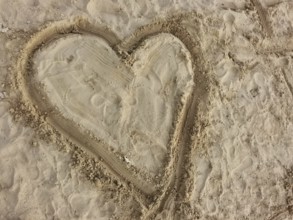 Heart drawn in sand on a beach