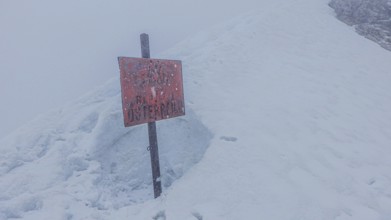 Snow-covered landscape with a sign Republic of Austria, on the way to Zugspitze during snowstorm,