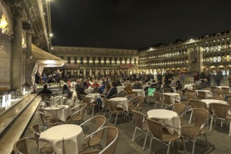 Café visitors at night concert in St. Mark's Square, Venice, Veneto, Italy