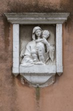 Relief of the Virgin and Child, 16th century, on a church façade, Venice, Veneto, Italy
