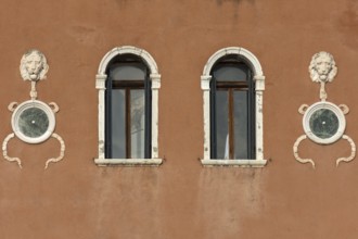 Sculptures of lion heads on a house wall, Venice, Veneto, Italy