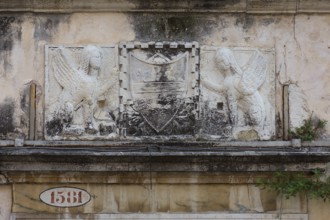 Relief over an entrance valley, two hybrid creatures, chimeras holding a coat of arms, Venice,