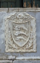 Coat of arms with three dolphins on a house wall, Venice, Veneto, Italy