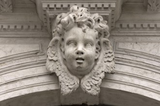 Sculpture of an angel's head above an entrance portal, Venice, Veneto, Italy