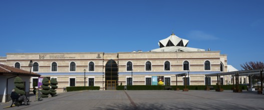 Long modern building with a flat roof and turquoise elements, Irfan Medeniyeti Arastirma ve Kültür