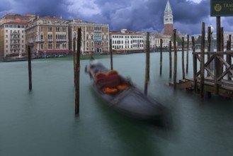Gondola anchored in the Grand Canal, St Mark's Campanile in the back, Venice, Veneto, Italy