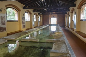 Historic wash house public washing place (Lavatoio) of Rio nell'Elba with running water and 18