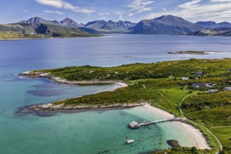 Aerial view over island Sommaroy, sandy beaches, mountain range in the back, Norway
