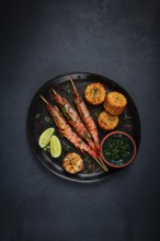 Langoustines on skewers, shrimp kebab, with fried corn, spices and herbs, homemade, no people
