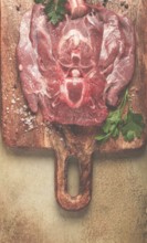 Raw steak, veal neck on the bone, fresh meat, on a cutting board, with spices, top view, without