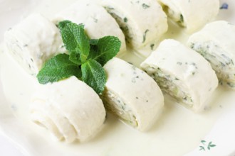 Gebjalia, a traditional Megrelian dish, cold appetizer of cheese with mint, Georgian cuisine, on a