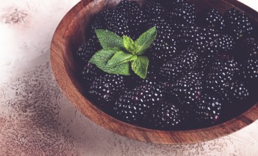 Blackberries, in a wooden bowl, top view, no people