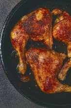 Baked chicken legs, with crispy skin, served in a pan, rustic style, homemade, no people