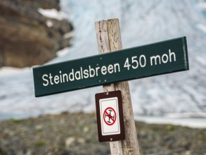 Signpost at glacier Steindalsbre, drones prohibited, Lyngen Alps, Norway