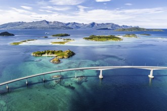 Sommaroy Bridge connecting Kvaloya Island to Sommaroy Island, small islands, mountain range in the