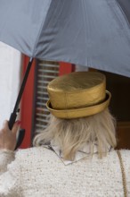Woman with umbrella and golden hat, Venice, Veneto, Italy