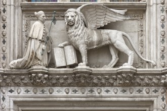 Doge kneels in front of St. Mark's Lion above the Porta della Carta of the Doge's Palace, Venice,