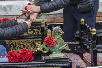 Tourist pays by mobile phone in a gondolier, Venice, Veneto, Italy