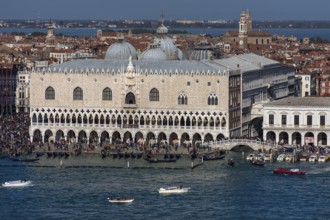 Doge's Palace with Bridge of Sighs, domes of St. Mark's Basilica, Grand Canal in front, Venice,