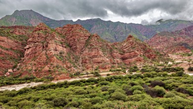 Wild, mountainous landscape with red rocks and thick clouds, The landscape and colorful rock