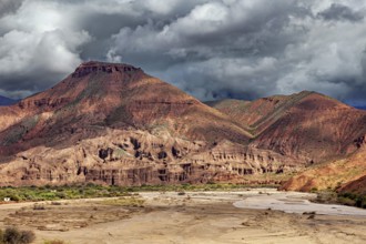Dramatic mountain landscape with clouds and rocky areas in the foreground, the landscape and